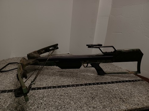 Camouflage Barnett QUAD-300 system 4 crossbow with compound limbs and visible “QUAD-300” text on the stock.