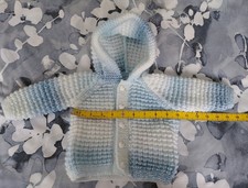 Hand knitted baby boy's blue and white marbled raglan hooded jacket