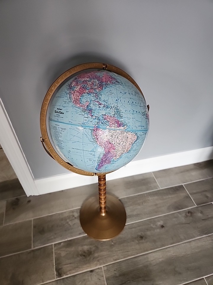 A proper Cram's Imperial floor globe on a brass and wood stand — the kind of thing you'd find in a Victorian gentleman's study.