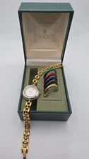 Gucci 1100L  Lady's Gold Plated Bracelet Watch with Six Interchangeable Bezels.