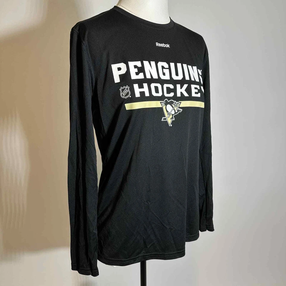 NUEVO CON ETIQUETAS Pittsburgh Penguins Reebok Play Dry Camisa Manga Larga Juvenil Talla Grande 14-16 Foto 2 de 4