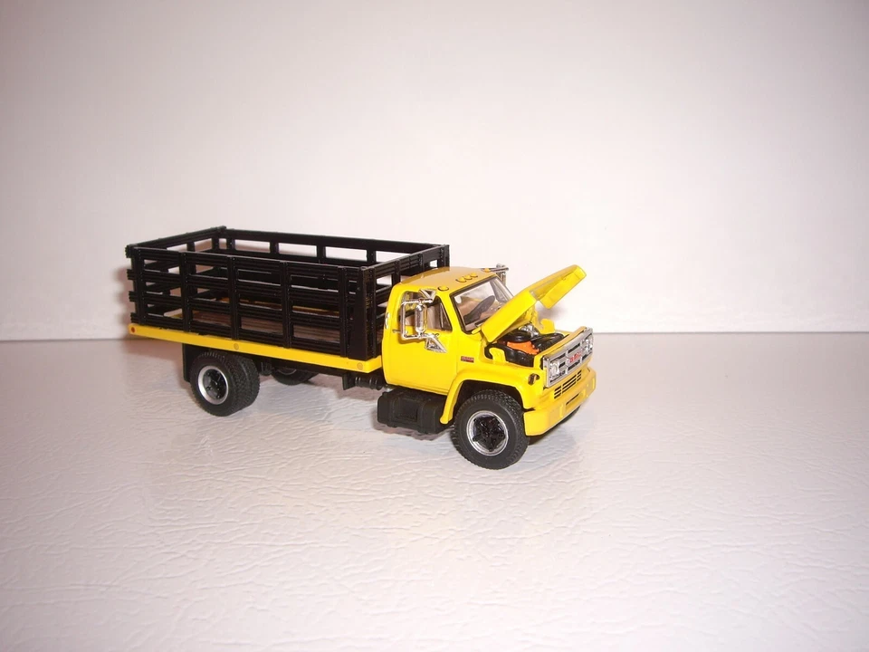 DCP FIRST GEAR 1/64 YELLOW CAB BLACK STAKE SIDE GMC 6500 SINGLE AXLE TRUCK  - Image 4 of 4
