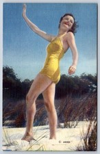 Vintage bathing beauty woman yellow swimsuit beach dunes 1940s