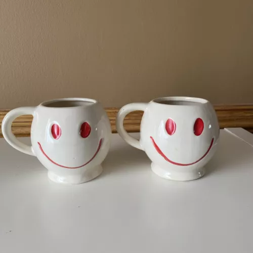 Two 2 1970s McCoy Pottery Smiley Face Mugs White with Red