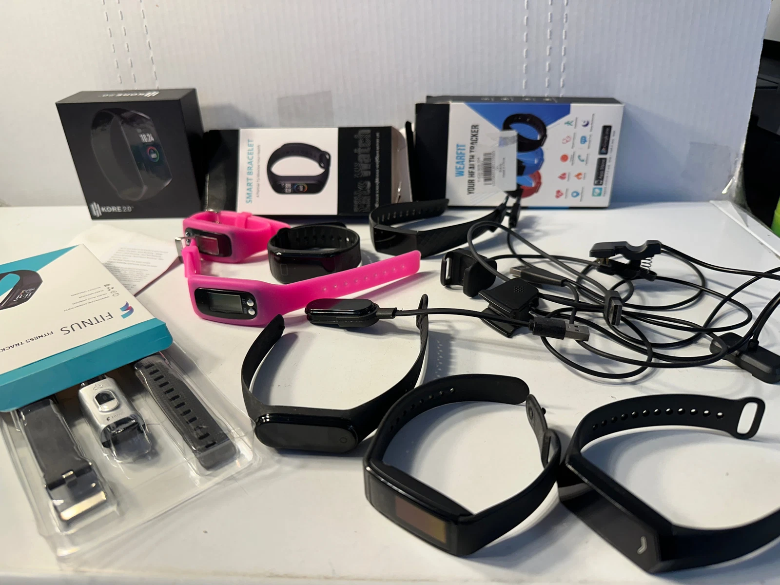 Fitness Tracker Watch Lot of 9 - With some chargers and some boxes.