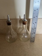 Pair of glass bitters bottles with stainless steel dasher tops