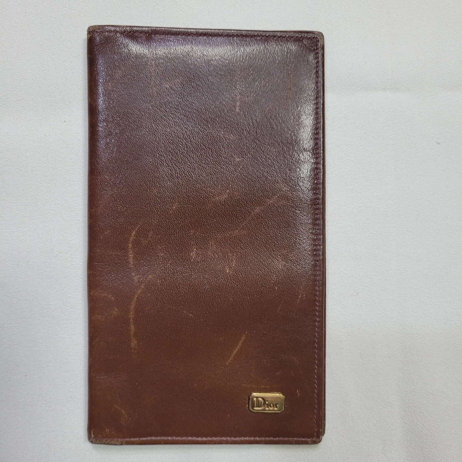 Portefeuille long vintage Christian Dior en cuir marron, prénom marqué Bretagne.