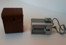 Used vintage Anscolite camera flash with leather pocket.