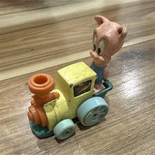 Vintage Wind-up Pig Character Toy on Yellow Train