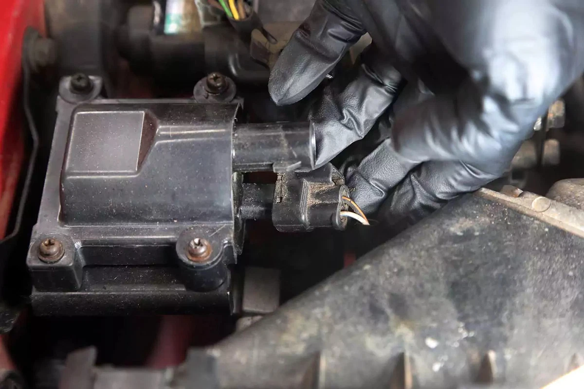 Holding wiring next to an ignition coil.