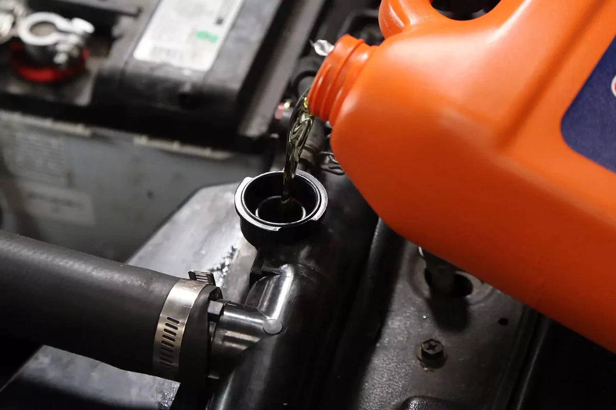 Refilling the radiator with coolant.