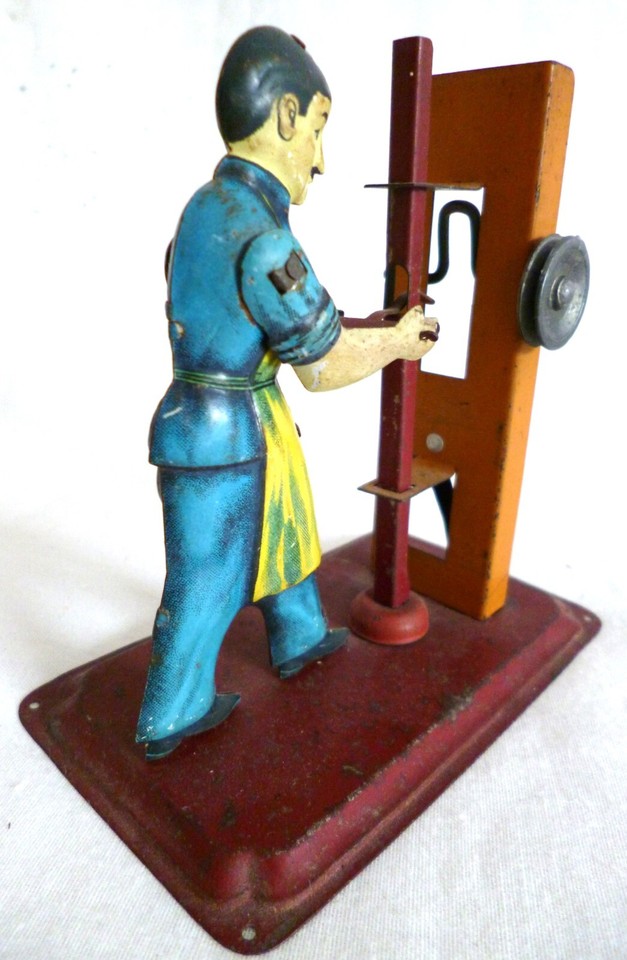 early 1920s man with a stamping press, a working model steam engine