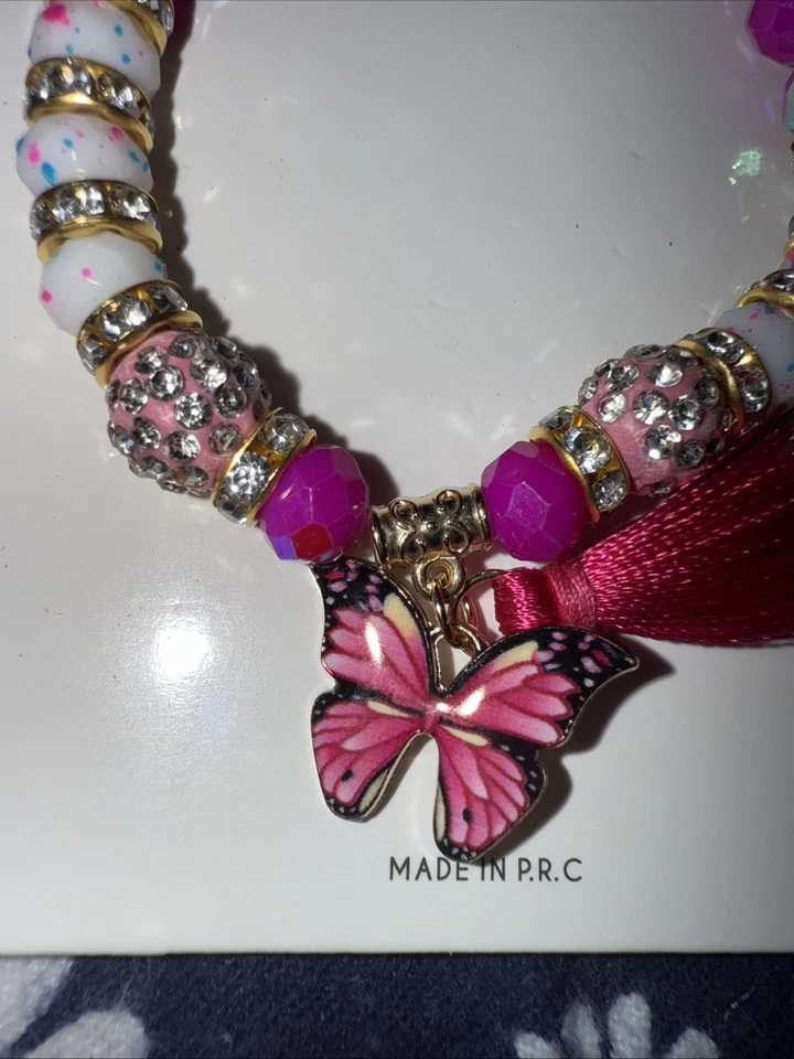 Pulsera expandible de cristal fucsia, blanco y dorado Foto 3 de 4