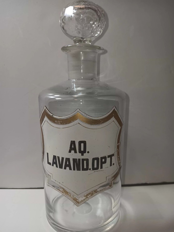 White enamel shielded apothecary bottle with faceted stopper.