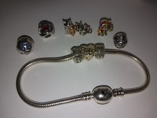 stunning silver chamilia bracelet with 9 beautiful charms.