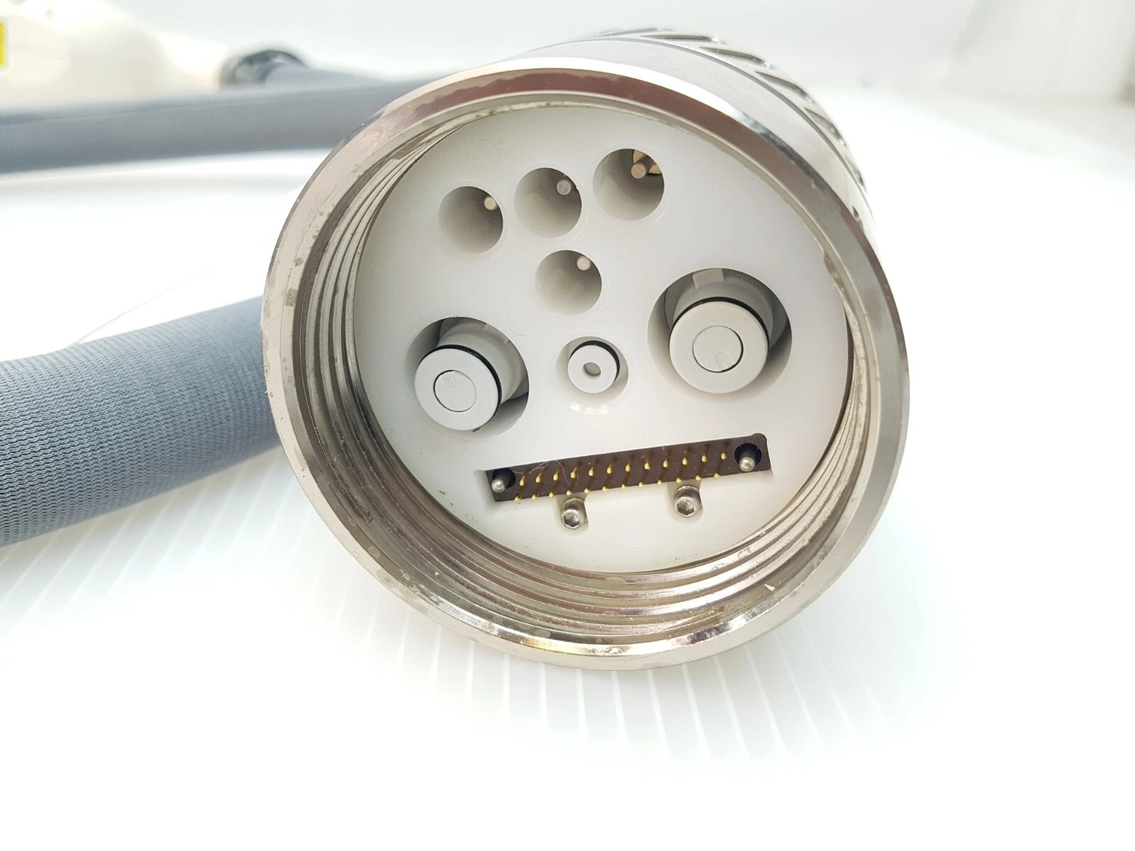 Connector face of the handpiece cable with multi-pin connector and round ports