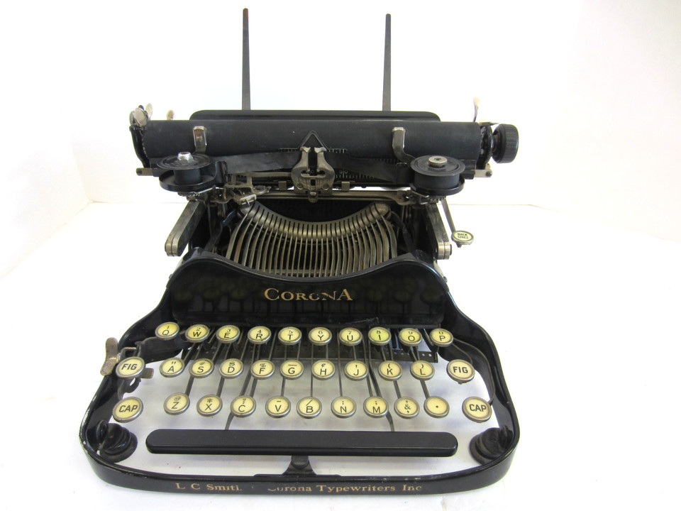 An L.C. Smith Corona FOLDING typewriter — one of the rarest form factors ever made, a true conversation piece and collector's holy grail.