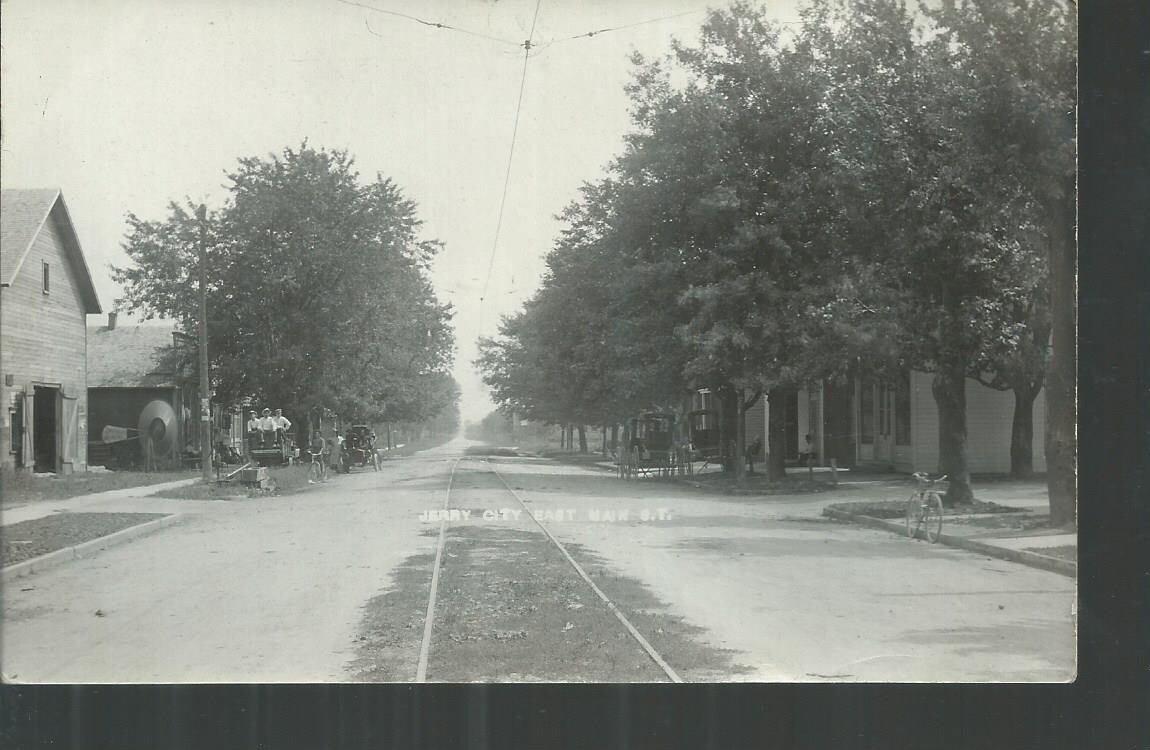 NICE EARLY RPPC VIEW OF EAST MAIN ST IN JERRY CITY, OH CARS AND WAGONS