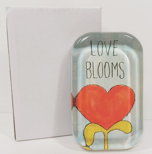 glass paperweight says love blooms with lovely heart artwork