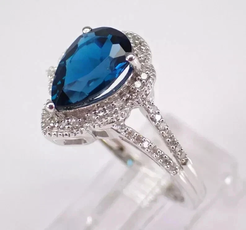 Anillo de mujer con halo de topacio azul Londres corte pera de 3,75 quilates oro blanco de 14 quilates Foto 2 de 4