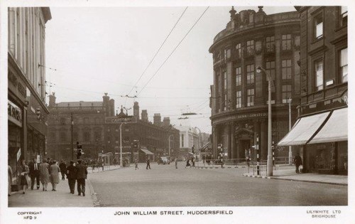 REAL PHOTO POSTCARD OF JOHN WILLIAM STREET, HUDDERSFIELD, WEST YORKSHIRE - Picture 1 of 2