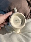 Cream ceramic mug with “Homer Laughlin Made in U.S.A. F 50 N 6” text on white porcelain base.