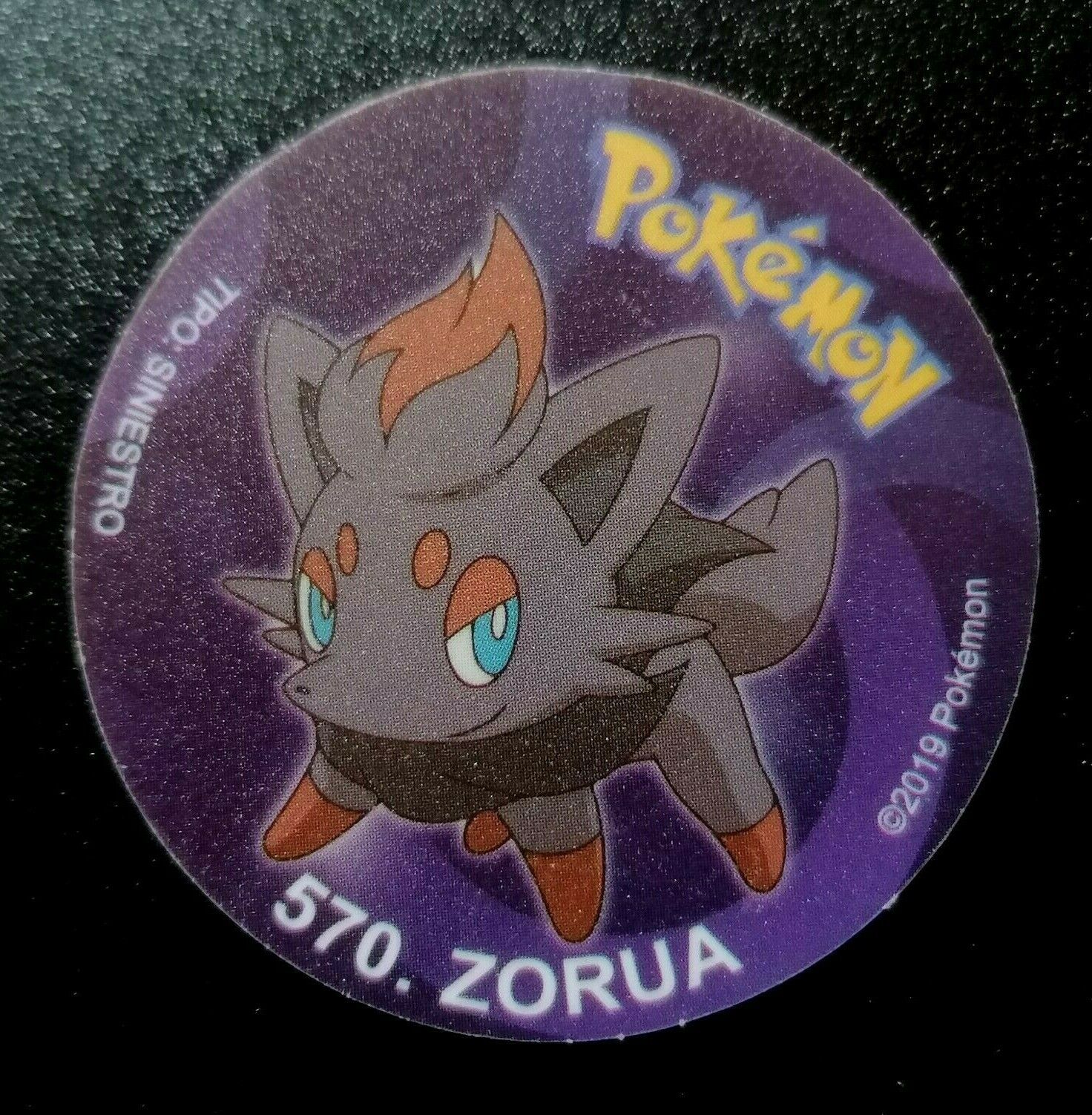 TAZO POKEMON DKV #570 ZORUA 2019 Unova PERU South America Pogs Taps