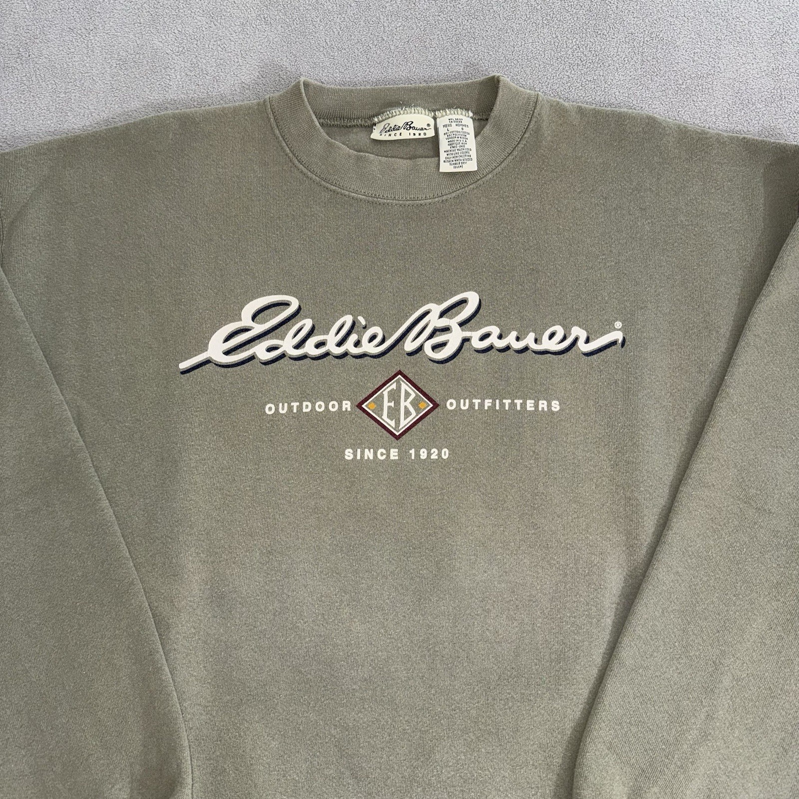 Gray vintage Eddie Bauer sweatshirt size L with white “Outdoor Hip Hop USA Made 90s” text and Eddie Bauer logo on chest.