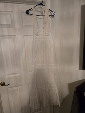 Tiered maxi dress with a halter neckline and delicate lace or eyelet detailing.