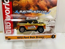 AUTO-WORLD X-TRACTION 1972 FORD BRONCO " BUCKIN BRONCO " NEW Aurora AFX