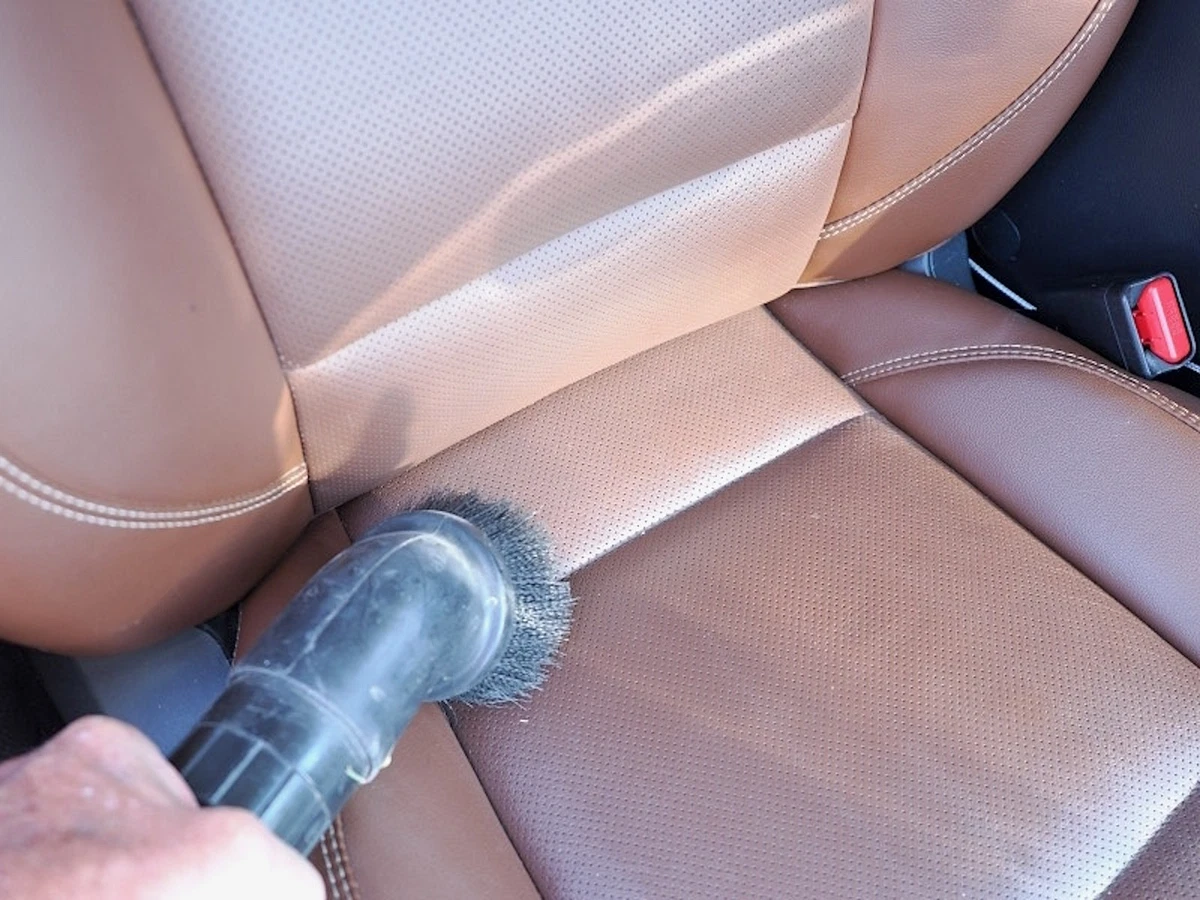 Vacuuming tan leather upholstery