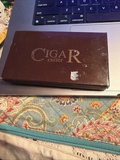 Stainless steel cigar cutter in decorative storage box