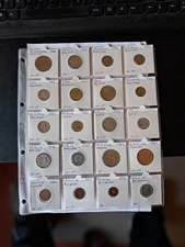 lot of world coins in coin holders