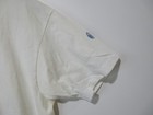 Light gray long-sleeve shirt with a blue ink round patch on the left sleeve, white club Newport cotton.