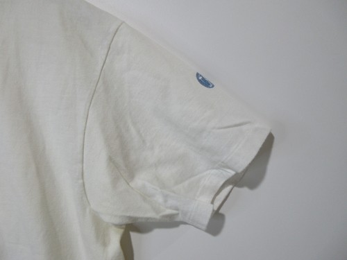 Light gray long-sleeve shirt with a blue ink round patch on the left sleeve, white club Newport cotton.