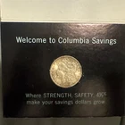 1884-O Morgan Silver Dollar In Columbia Savings And Loan Holder