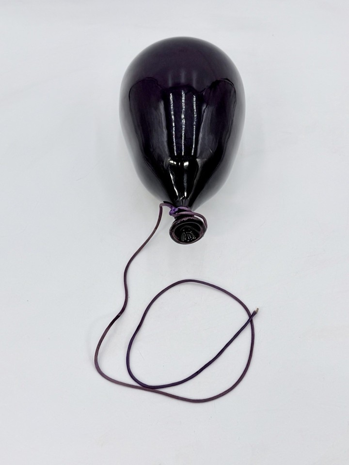 A vintage Dyer ceramic balloon in purple — bold pop-art energy meets mid-century craft in a single sculptural wall piece.