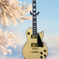 Cream-yellow electric guitar with black pickguard and mahogany body, 6-string