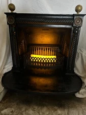 1800's classic wrought iron fireplace with brass fenestration.  