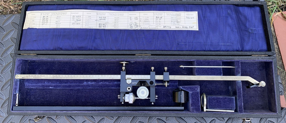 A polar planimeter — a beautifully obscure mechanical instrument that calculates area by tracing a shape's outline, pure analog witchcraft.