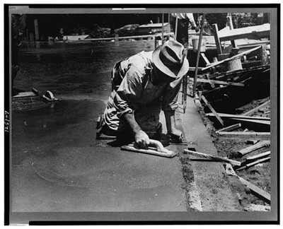 Photo:Worker leveling cement floor, Greenbelt, Maryland