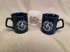 One Milk White Philip Morris Logo Cup and Two Scrimp Award ACT Blue Cups