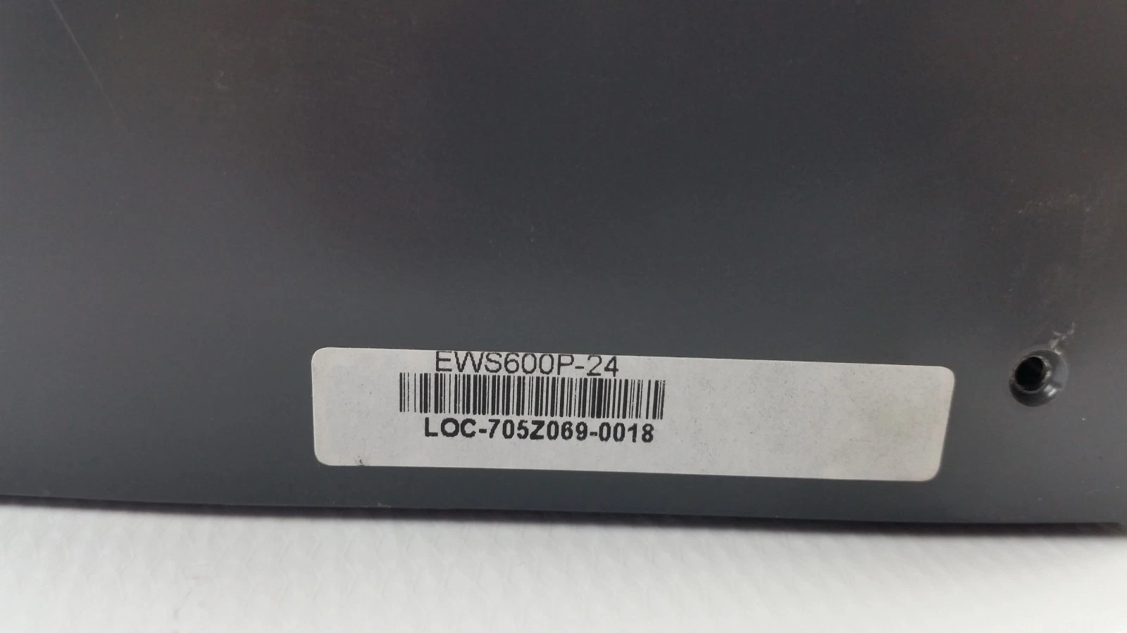 Side sticker reading EWS600P-24 with asset tag LOC-705Z069-0018