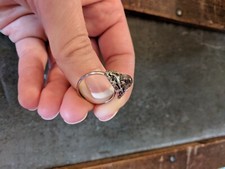 Silver toned ring with opal-like glass colored stone, adjustable