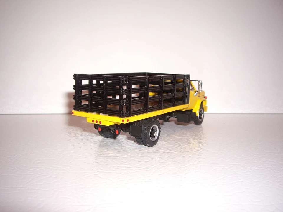 DCP FIRST GEAR 1/64 YELLOW CAB BLACK STAKE SIDE GMC 6500 SINGLE AXLE TRUCK  - Image 3 of 4