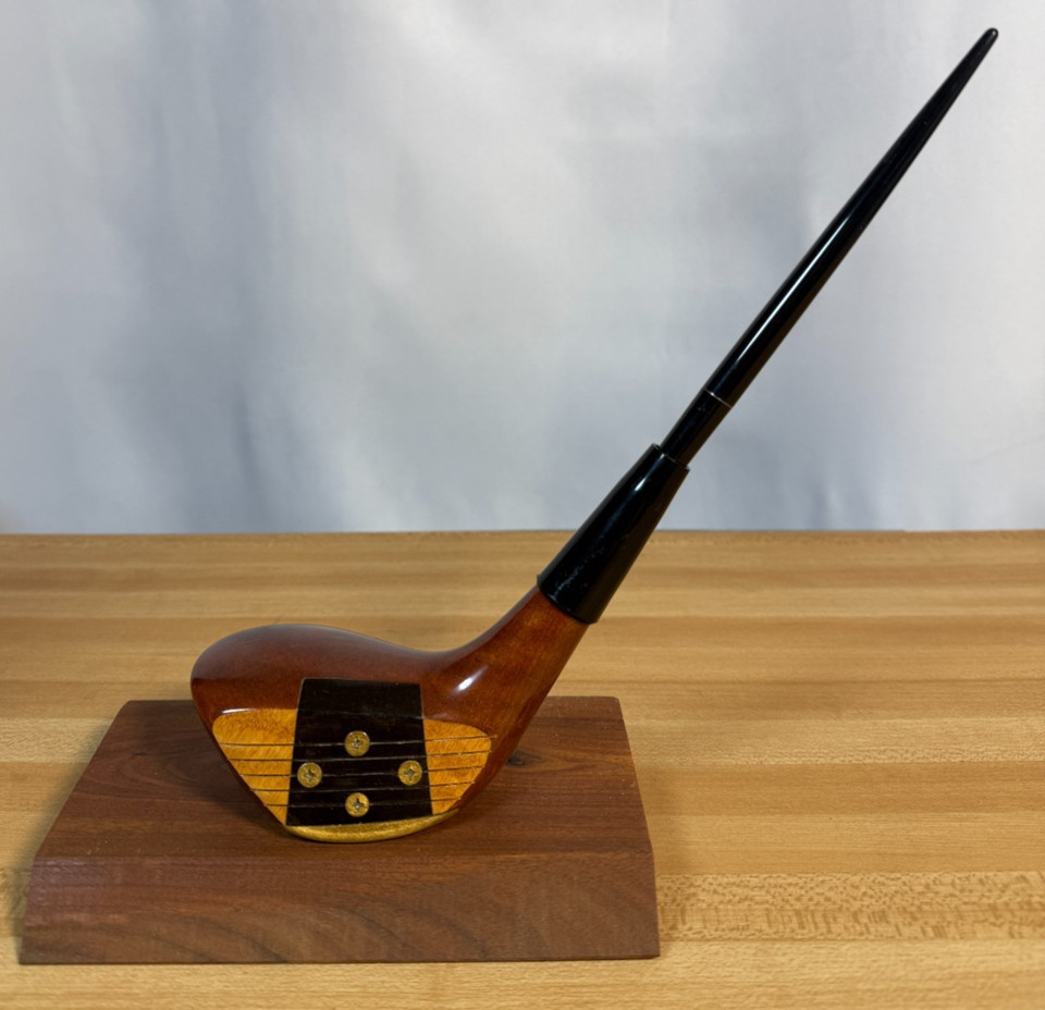 A real persimmon wood golf club head repurposed as a vintage pen holder — niche, tactile, and perfect for the golf obsessive.