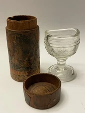 CLEAR GLASS PEDESTAL EYE WASH CUP 2 1/8" T & WOODEN QUACK MEDICINE CASE 2 7/8" T