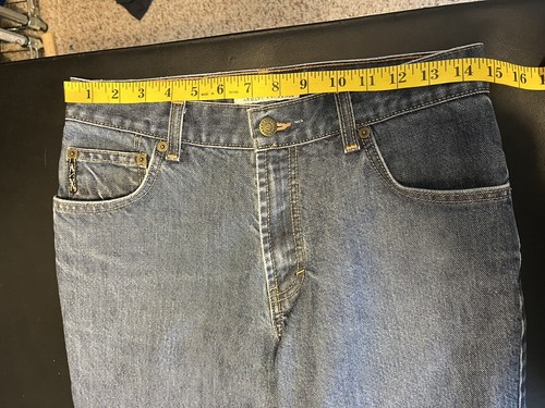 AX Armani Exchange J40 women’s blue short regular bootleg jeans with five pockets, yellow measuring tape across the waistband.