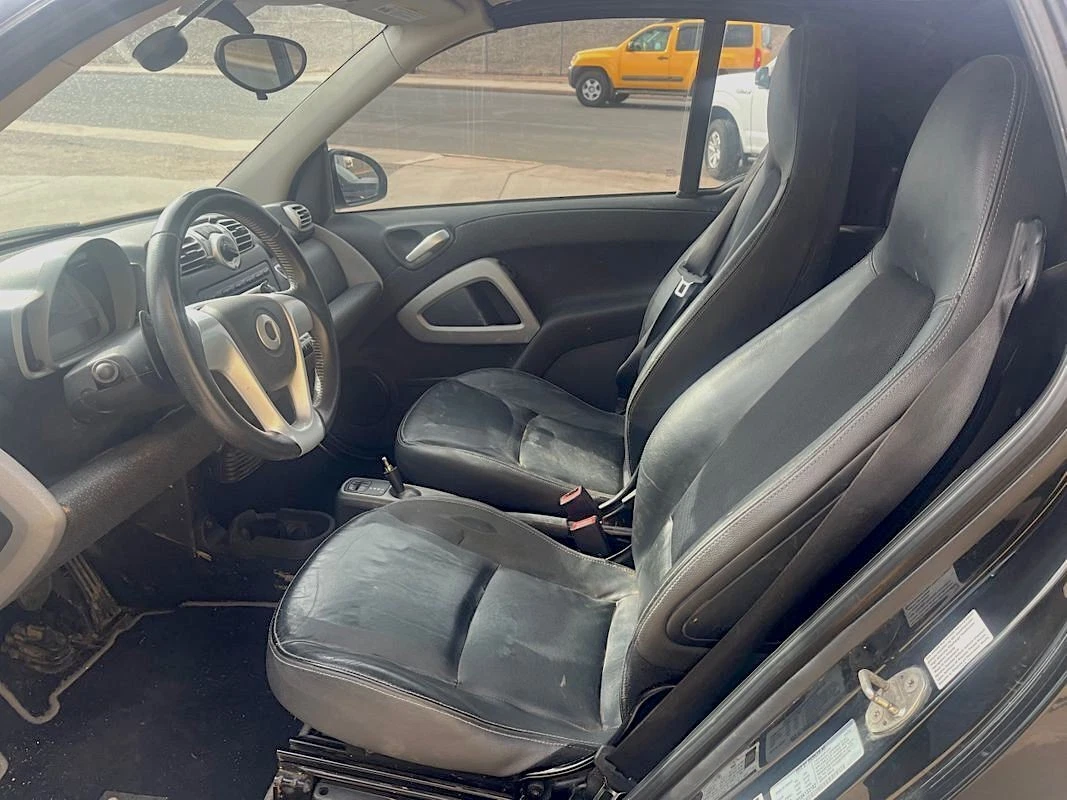 interior view from side - driver's seat and steering wheel