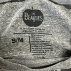 Grey cropped T-shirt with white “THE BEATLES” logo, size S/M, and product details in black text.